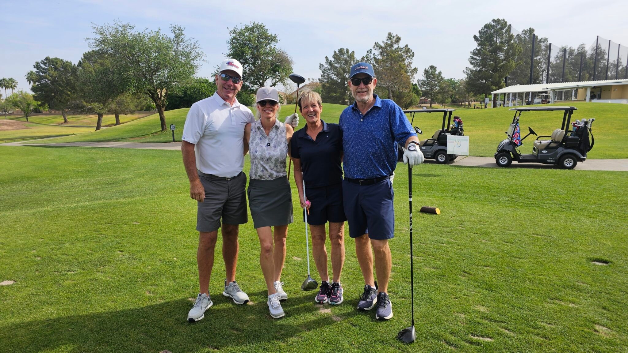 Golf team with clubs on the fairway at the BTG charity scramble